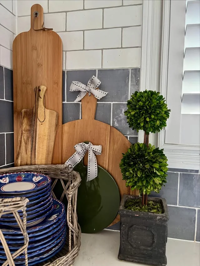 Cutting boards and greenery styled in a kitchen corner