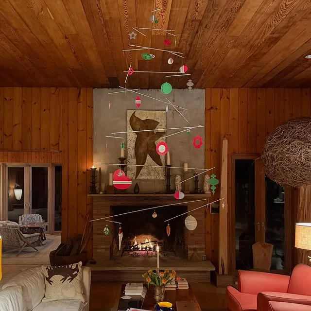 Mid century living room with hanging ornament mobile over the fireplace
