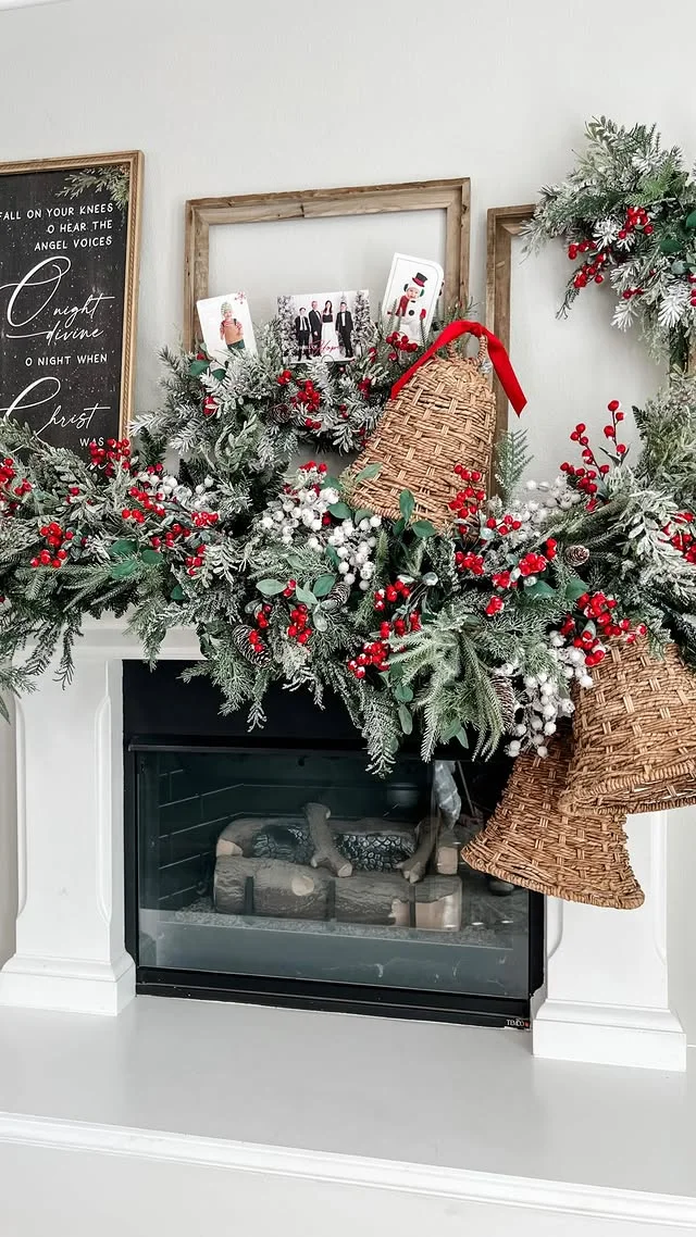 White mantel with frosted greenery, white bells, and red berries