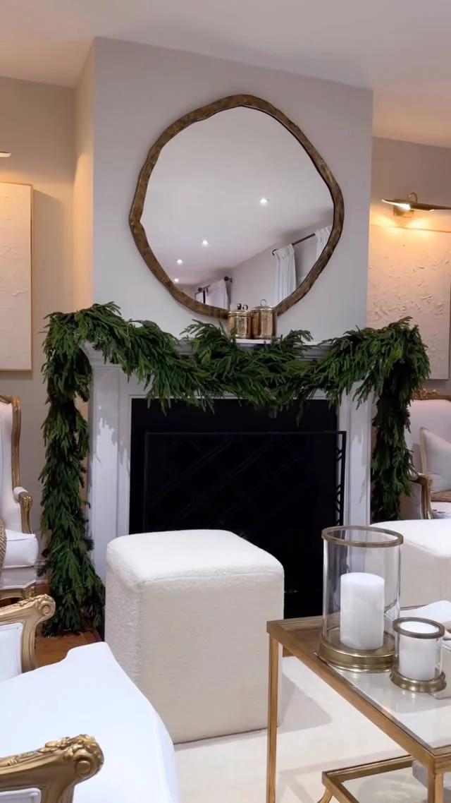 Minimalist green garland swag with a round mirror above