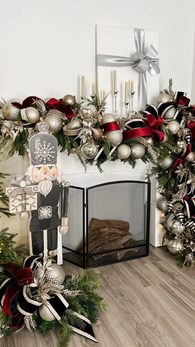 Festive mantel with a nutcracker and silver and red ornaments