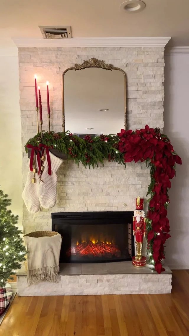 Red berry garland cascading down a white brick fireplace