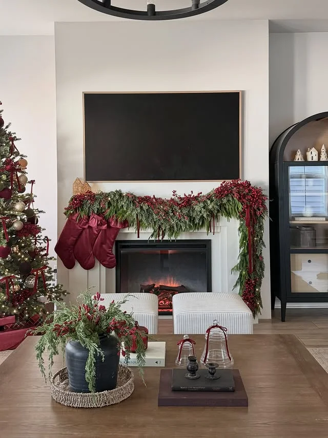 Brick fireplace with white knit stockings and green garland