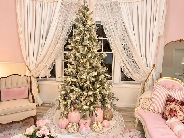 Pink living room with flocked christmas tree decorated in pink and gold ornaments