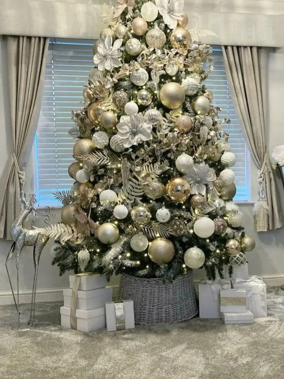 Christmas tree decorated with gold, champagne and silver ornaments