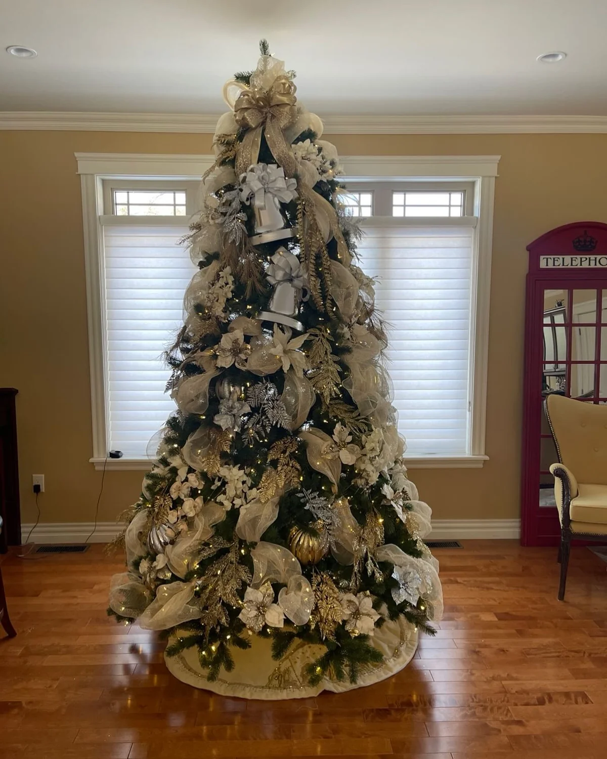 Christmas tree in white, cream and gold with sheer ribbons and poinsettias