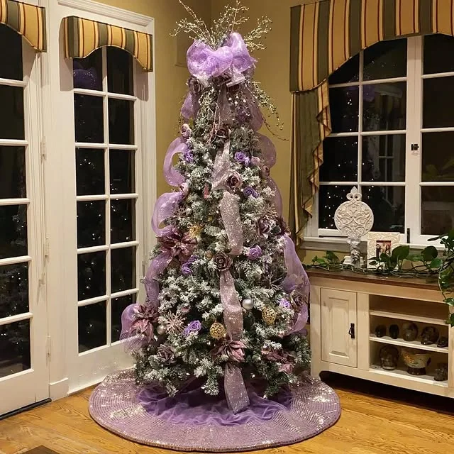 Flocked christmas tree decorated with purple and lavender ribbons