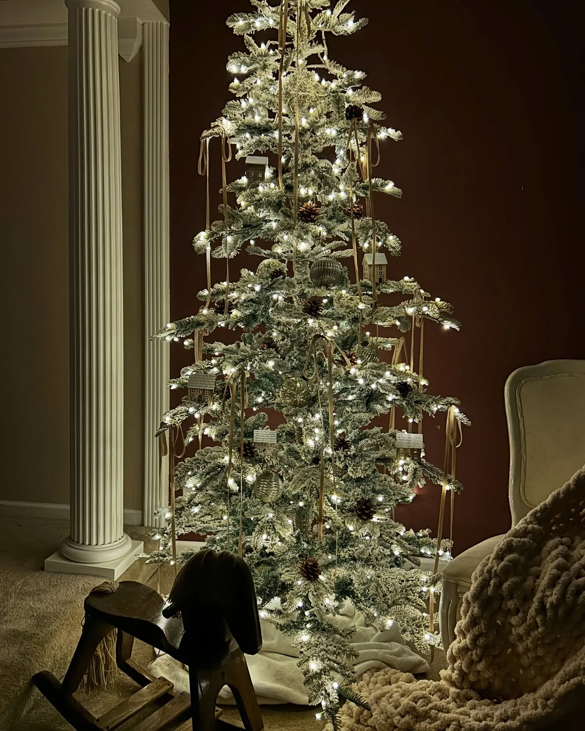 Flocked christmas tree with simple neutral decorations and warm lights