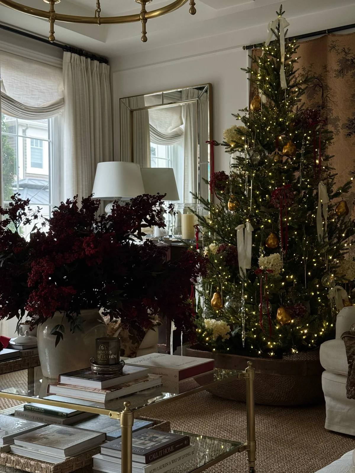 Christmas tree with white ribbon bows, red velvet ribbons and gold ornaments