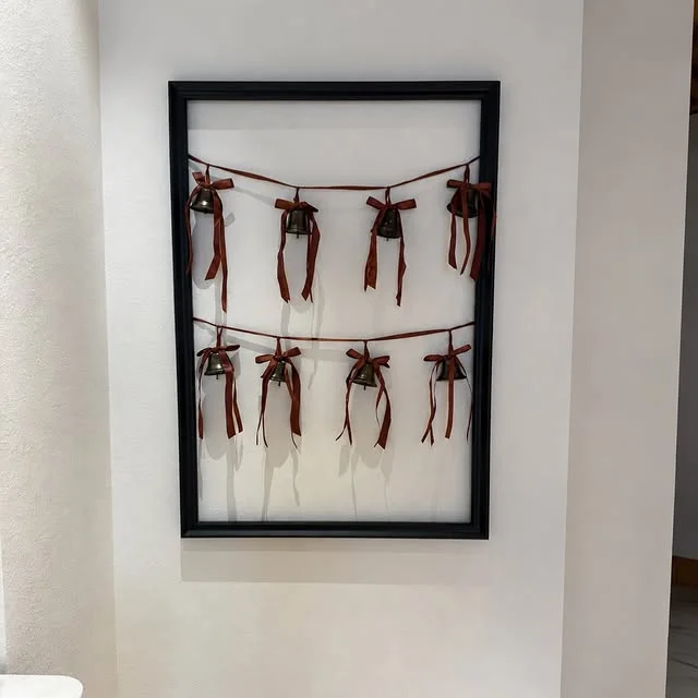 Framed black ribbon card holder displaying Christmas cards
