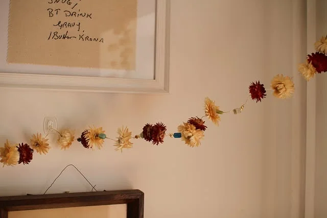 Dried strawflower garland strung across an interior wall