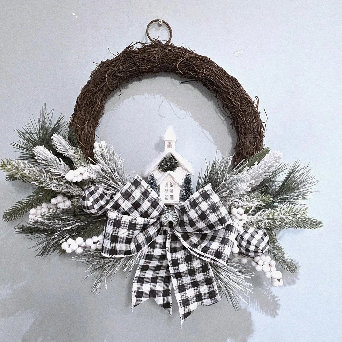 Twig wreath with frosted greenery, white berries and buffalo check bow