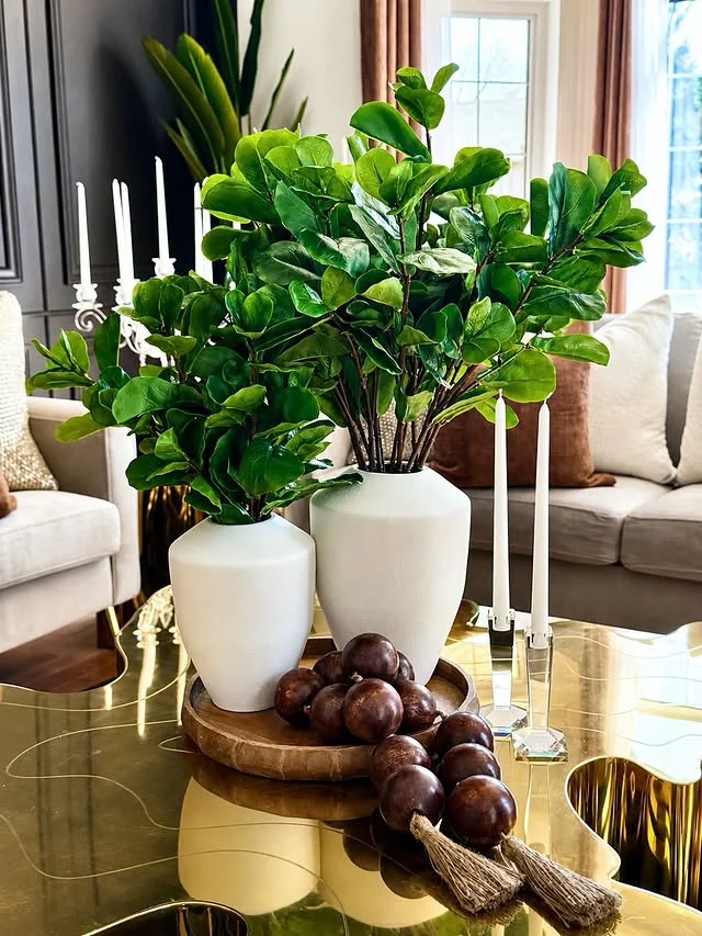 Styled coffee table with vases, candles and a wooden tray