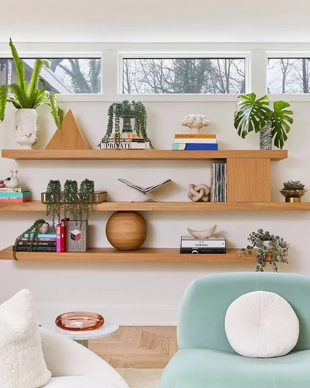Styled floating shelves on a living room wall