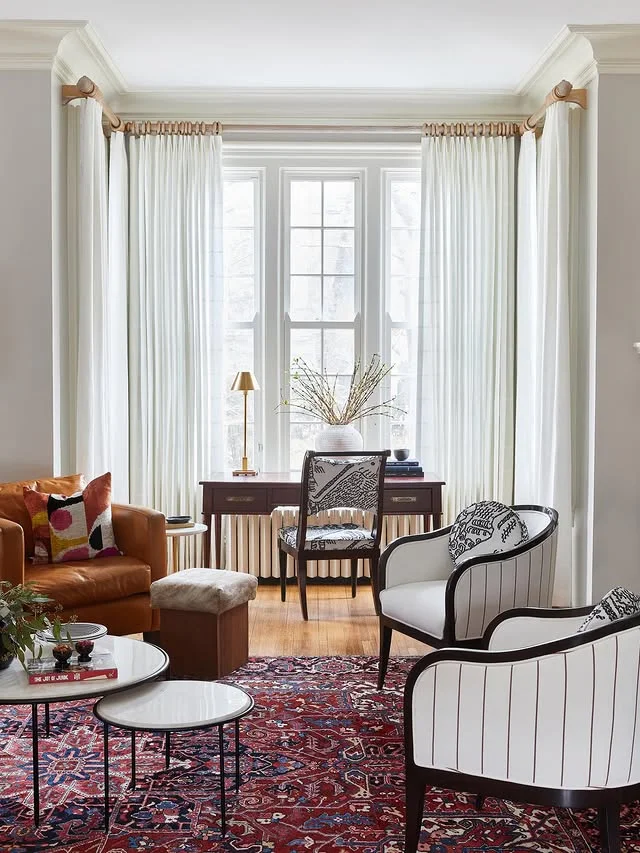 Sheer white curtains on large living room windows