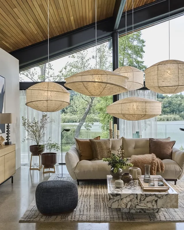 Sunlit modern living room with woven pendants and linen sofa