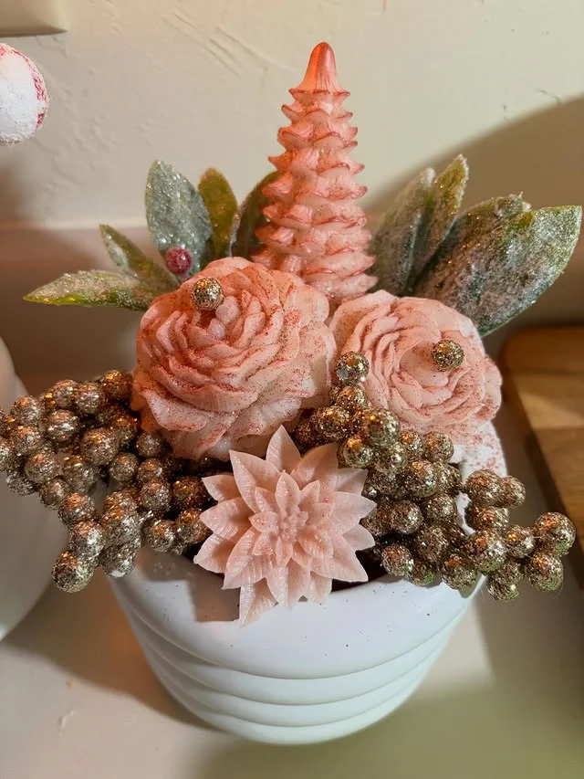 Blush pink flower arrangement with glittered gold berries in a white pot